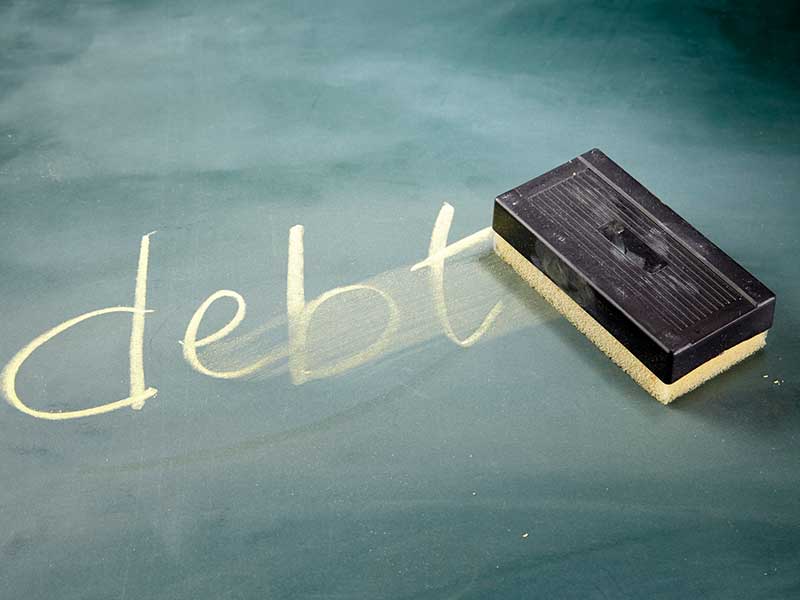 the word "debt" on chalkboard being erased