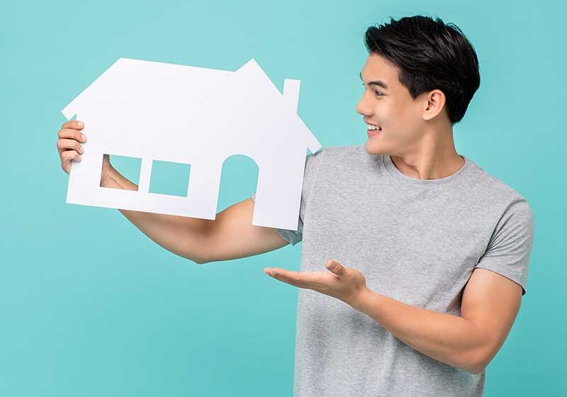 man holding house cutout